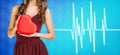 Woman present heartbox beside pulse line Royalty Free Stock Photo