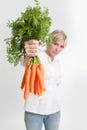 Woman presenting a bunch of carrots Royalty Free Stock Photo