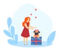 Woman presenting a gift to a happy dog sitting on boxes. Red dress lady with ginger hair giving present to a pet. Gift