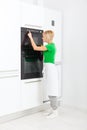 Woman press button modern kitchen appliance