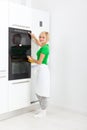 Woman press button modern kitchen appliance