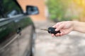 Woman press unlock button on key car remote control Royalty Free Stock Photo