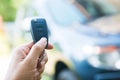 Woman pressed on the remote to open the car Royalty Free Stock Photo