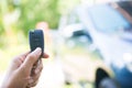 Woman pressed on the remote to open the car Royalty Free Stock Photo