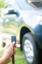 Woman pressed on the remote to open the car Royalty Free Stock Photo