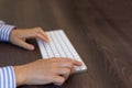 A woman presses her finger on a white keyboard key for a computer Royalty Free Stock Photo