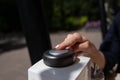 Woman pressing button to call waiter in cafe.