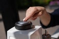 Woman pressing button to call waiter in cafe.