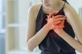 Woman pressing on chest with painful expression, Severe heartache, Having heart attack or Painful cramps, Health care concept