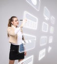 Woman pressing high tech type of modern multimedia buttons on a virtual background Royalty Free Stock Photo