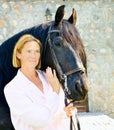 Woman with pretty black horse Royalty Free Stock Photo