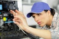woman printer at stage looking at machine Royalty Free Stock Photo