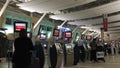 Woman printing out luggage tag at Air Canada machine inside YVR Airport