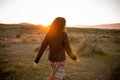 Woman in a pristine landscape during a beautiful blazing sunset Royalty Free Stock Photo