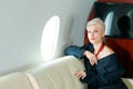 Woman private plane in a jacket with a red tie, New Year& x27;s Eve flight, holiday and travel