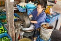 Woman processing coconuts