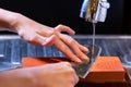 woman professional chef hands hold knife for whetting on whetstone.premium professional stone from japan.knife sharpening process Royalty Free Stock Photo