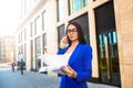 Woman professional government worker in classic glasses and suit talking via mobile phone Royalty Free Stock Photo