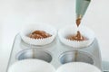 Woman professional pastry chef spreads chocolate dough in baking dish