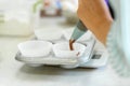 Woman professional pastry chef spreads chocolate dough in baking dish