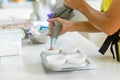 Woman professional pastry chef spreads chocolate dough in baking dish