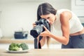 Woman professional photographing plate with broccoli. Food photographer working in kitchen studio Royalty Free Stock Photo