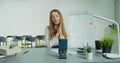 Woman professor sitting at table and lecturing online at class. Female English teacher in glasses speaking on smartphone Royalty Free Stock Photo