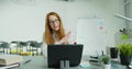 Woman professor sitting at table and lecturing online at class. Female English teacher in glasses speaking on tabletPC Royalty Free Stock Photo