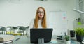 Woman professor sitting at table and lecturing online at class. Female English teacher in glasses speaking on tabletPC