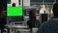 Woman programer looking at greenscreen and code on terminal window