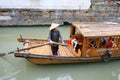 Woman propelling a water taxi on canal Royalty Free Stock Photo