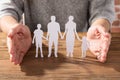 Woman Protecting Family Of White Paper Cut Out