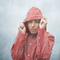 Woman, protection and portrait with rain, coat and clouds with safety in nature. Girll, face and storm with cloudy Royalty Free Stock Photo