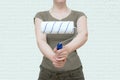 Woman in protective clothing with paint roller in her hands. Painting the walls of the room Royalty Free Stock Photo