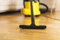 Woman in protective gloves cleaning the living room with yellow vacuum cleaner. Copy space. Clean concept Royalty Free Stock Photo