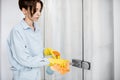 Woman cleaning door handle at home Royalty Free Stock Photo