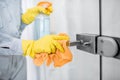 Woman cleaning door handle at home Royalty Free Stock Photo