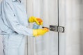 Woman cleaning door handle at home Royalty Free Stock Photo