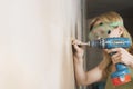 Woman In Protective Goggles Drilling Wall Royalty Free Stock Photo