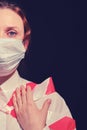 Woman in a protective mask on a dark background, half face. Close-up of a red-haired girl in a white shirt tied stop tape Royalty Free Stock Photo