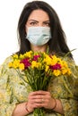 Woman with protective mask and freesias