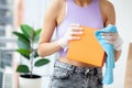 Woman in protective medical gloves disinfecting purchases