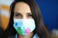 Woman in protective medical mask with coronavirus stickers