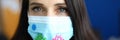 Woman in protective medical mask with coronavirus stickers