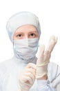 Woman in a protective suit wears disposable sterile gloves