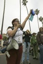 A woman protester with a loud speaker gestures with her arm to the crowd at an anti-Iraq War protest march in Santa Barbara, Calif