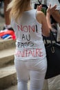 Woman protesting against the sanitary pass text in french : non au pass sanitaire, english no at the sanitary pass