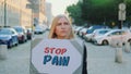 Woman protesting to stop pain by holding steamer