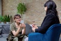 Woman psychologist having therapy session with middle aged military female Royalty Free Stock Photo