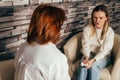 Woman psychologist talking to patient girl. Consultation with counsellor Royalty Free Stock Photo